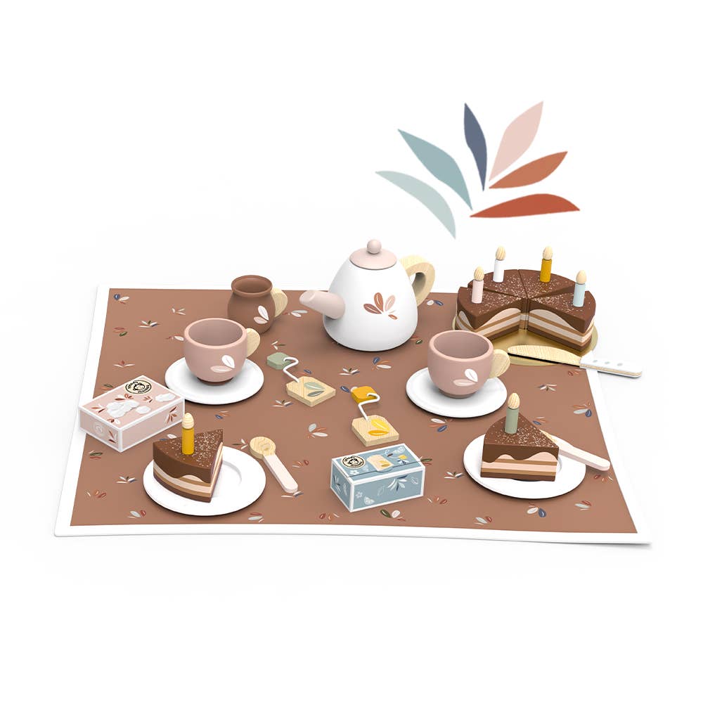 Wooden birthday tea set with teapot, teacups, and cake slices on white saucers, all set on a cozy floral background.