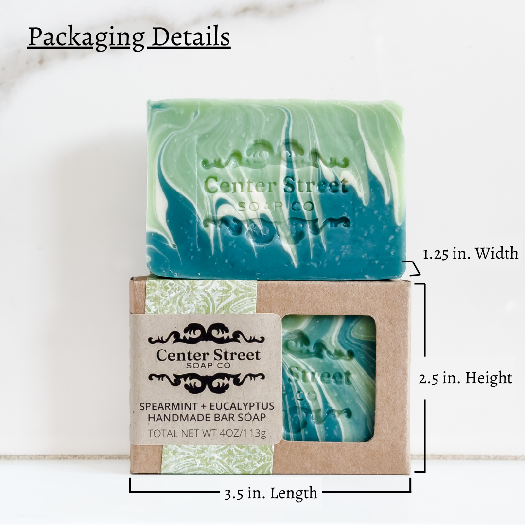 Handmade vegan soap bar with spearmint and eucalyptus, featuring a green and blue marbled design.