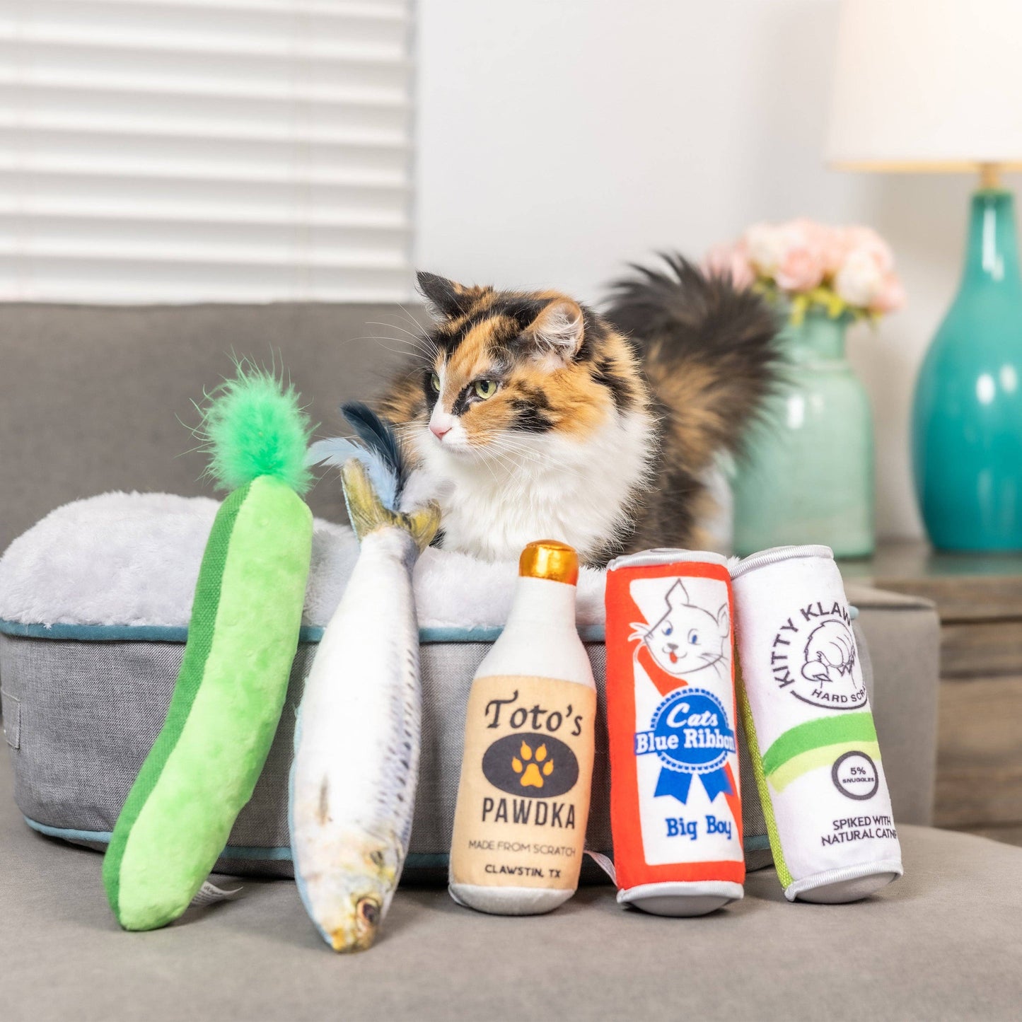 Plush cat toy set including a crinkle pickle, fish, bottle, can, and tube, all filled with catnip.
