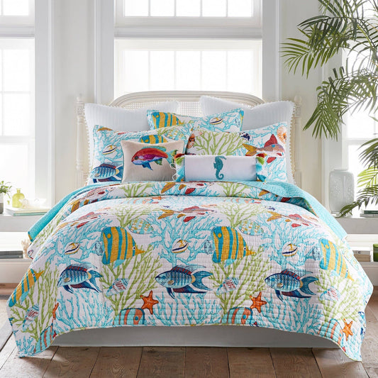 Colorful coastal-themed quilt set with tropical fish and coral design on a bright bed