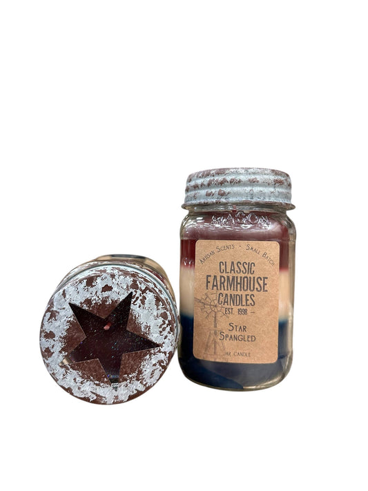 Red, white, and blue layered candle in a rustic jar labeled "Star Spangled", with distressed lid and star cutout.