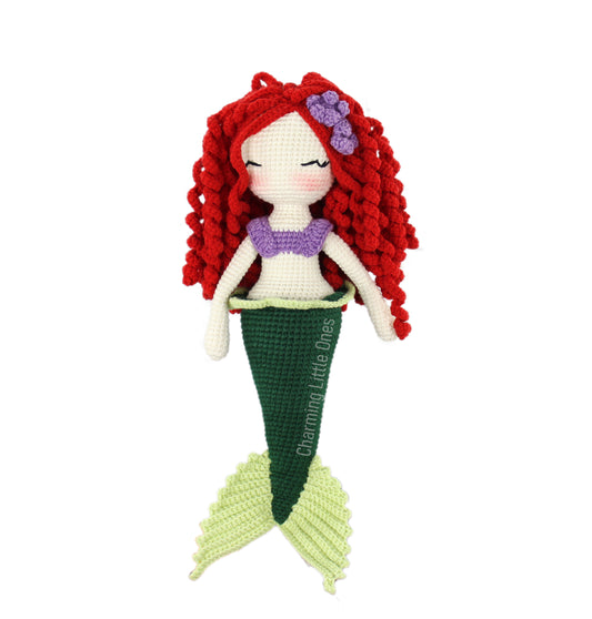 Handmade crochet mermaid doll with red hair, purple top, and green tail, perfect for cuddling.