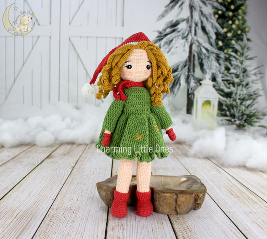 Crochet doll with curly yellow hair, red hat, green dress, and red boots, perfect for Christmas.