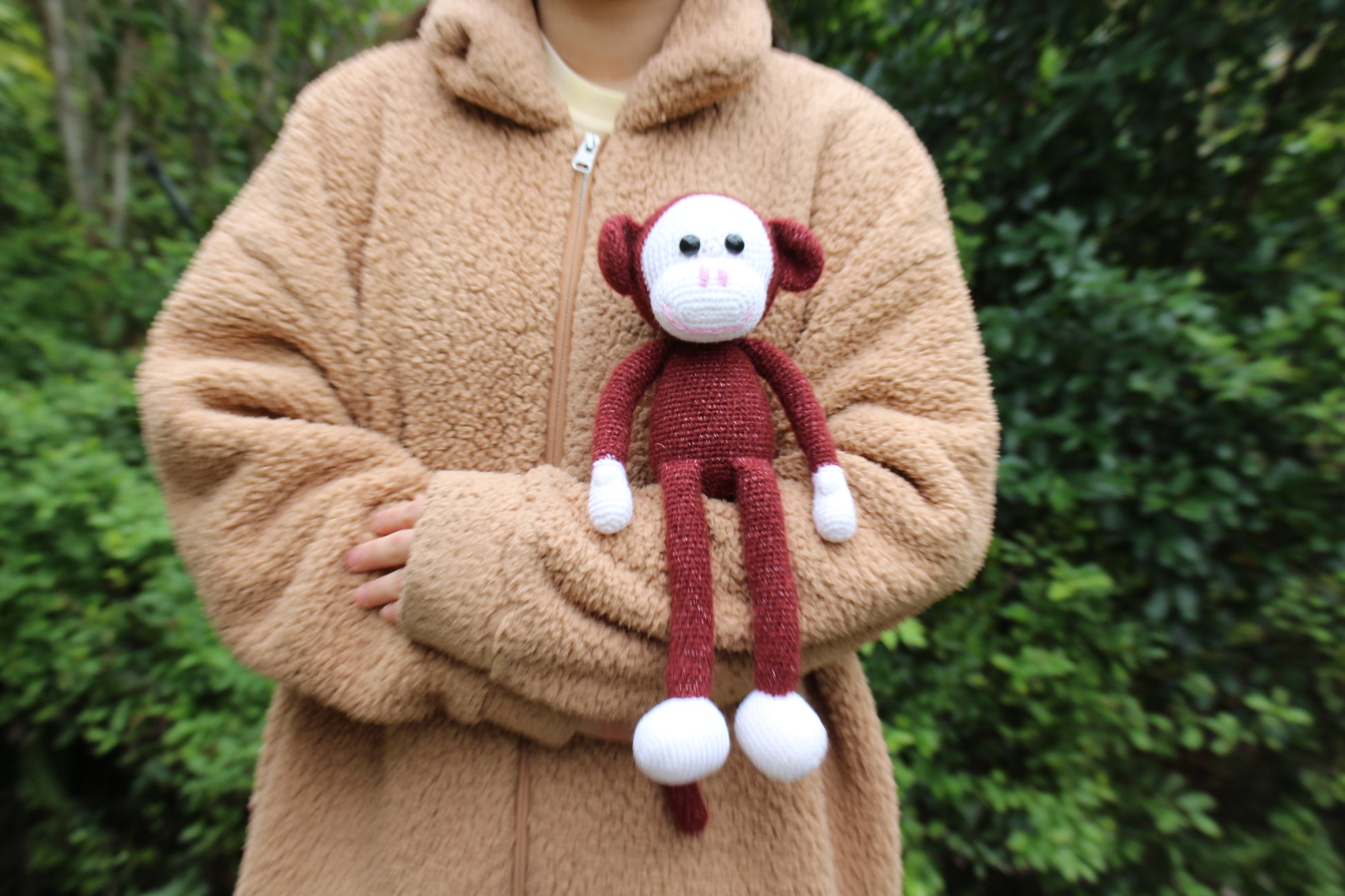 Handmade 13-inch crochet monkey doll in red with white accents, crafted from soft yarn.