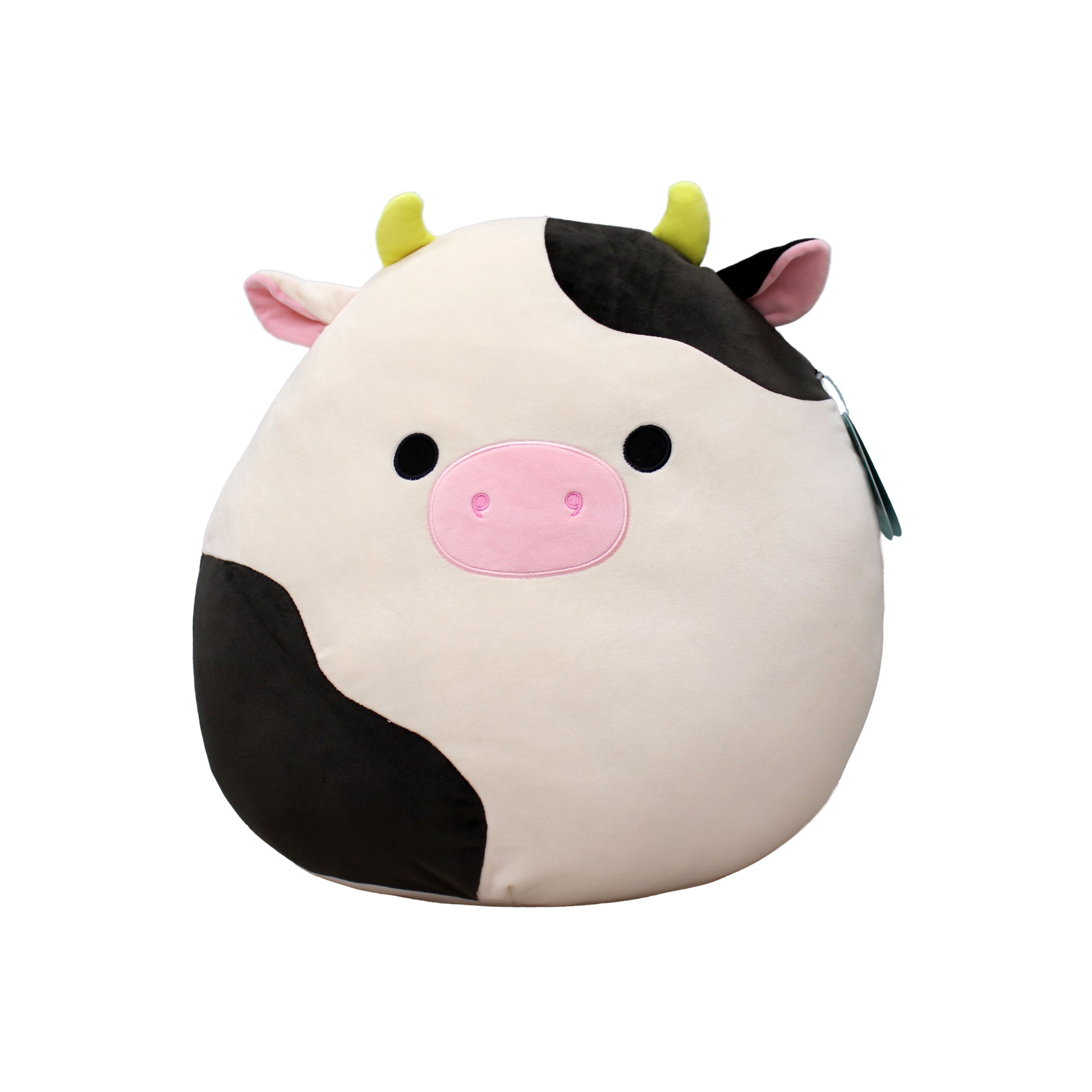 A large, soft plush cow with black and white spots, pink nose, and yellow horns.