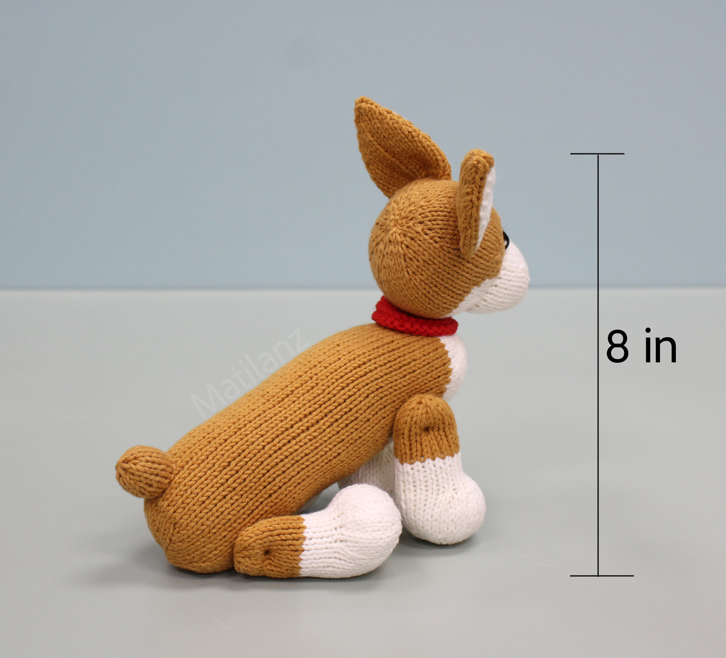 Brown and white handmade knitted corgi plush toy with a red collar, 8 inches tall.