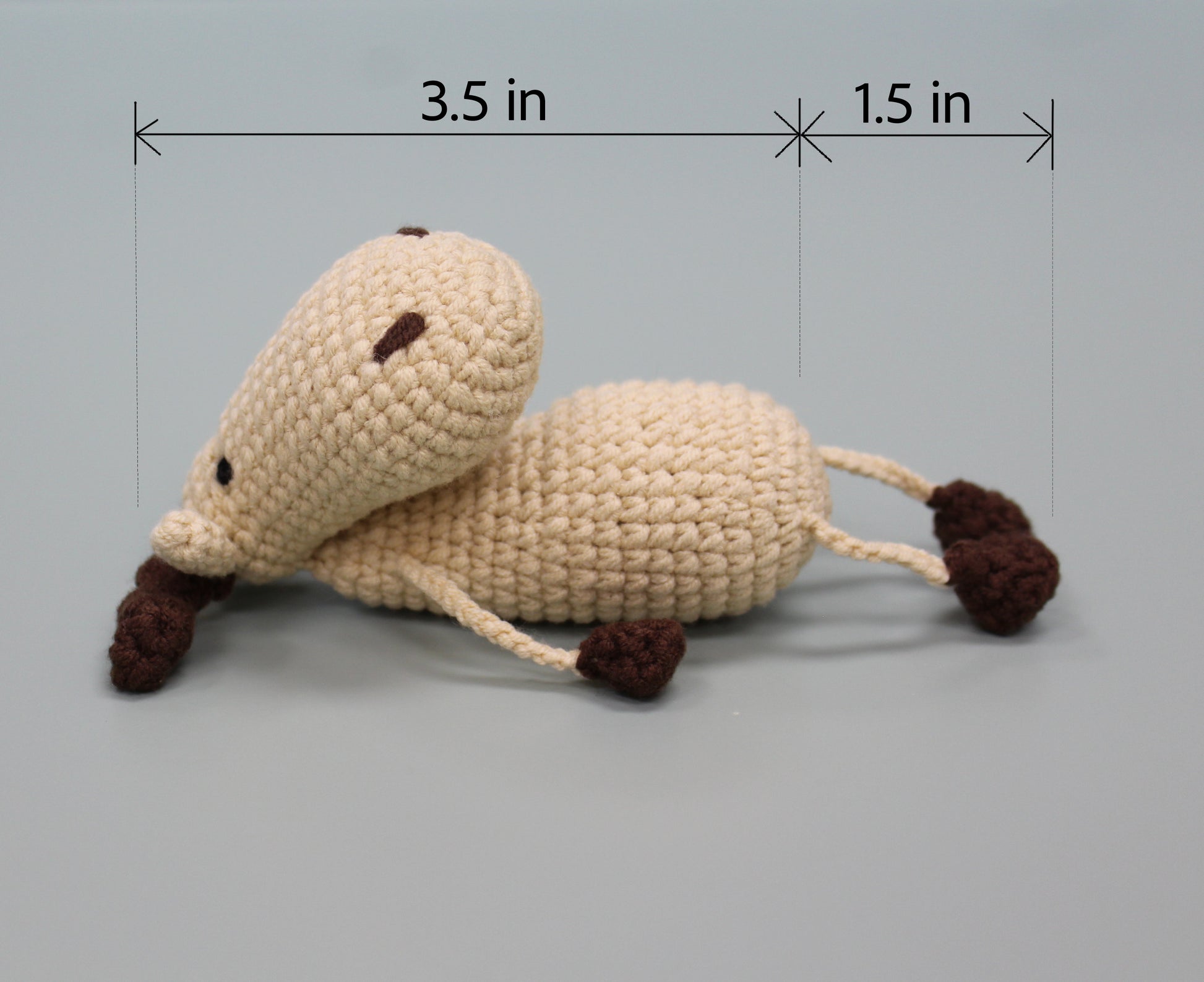 Handmade crochet moose keychain in cream and brown, measuring 3.5 inches long.
