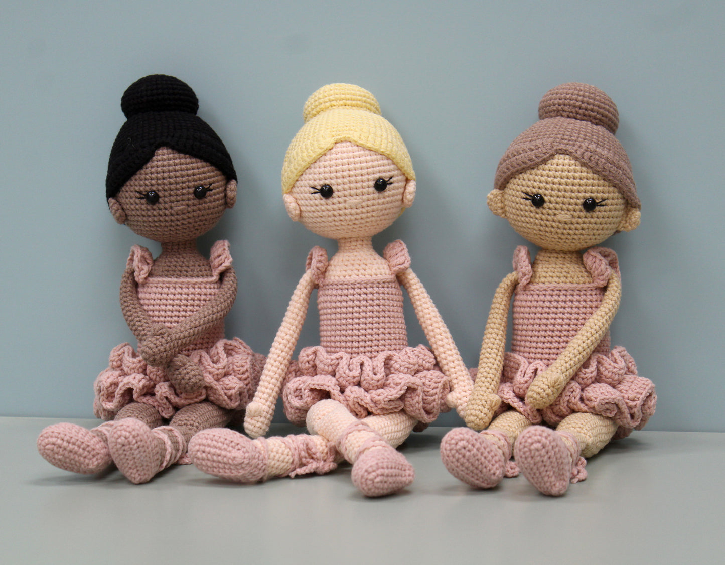 Handmade crochet ballerina doll plush in soft pastel shades with ruffled skirts.