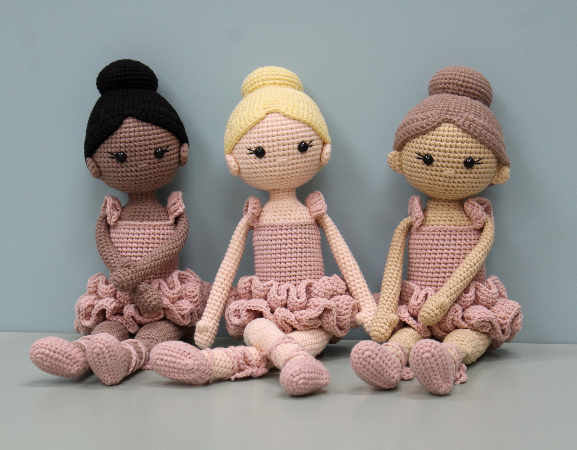 Handmade crochet ballerina doll plush in soft pastel shades with ruffled skirts.