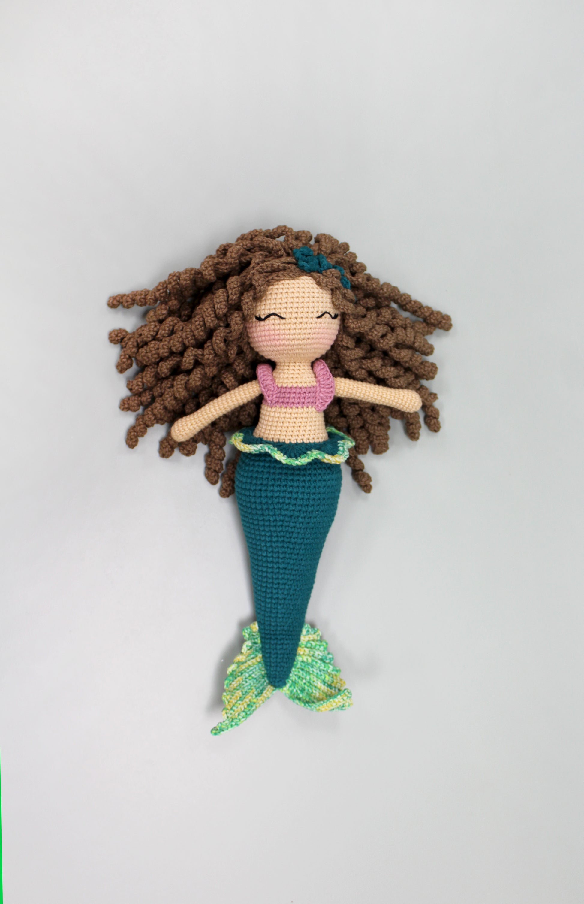 Handmade crochet mermaid doll with brown hair, pink top, and teal tail, 12 inches long.