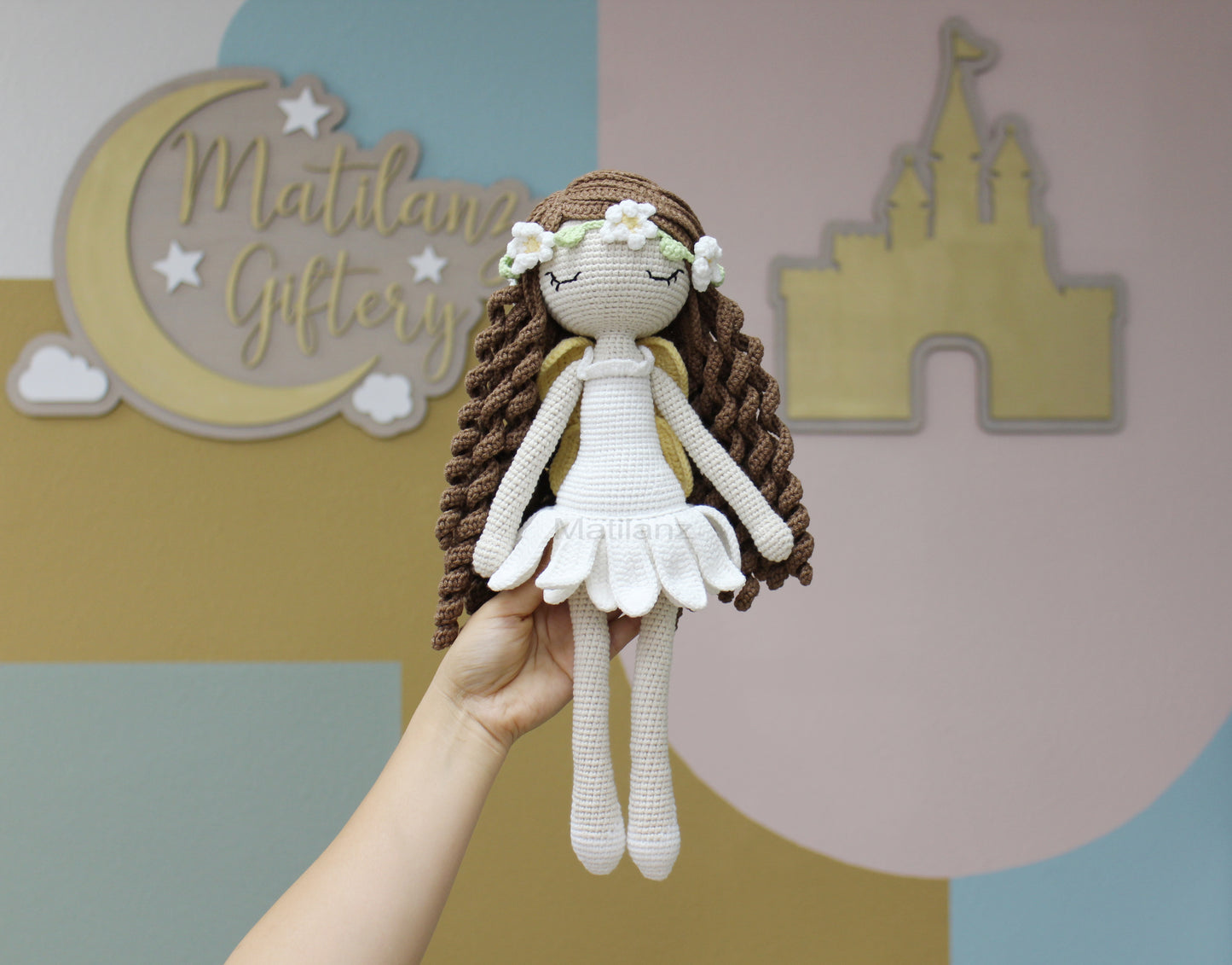 Handmade crochet fairy doll with long brown hair, white dress, and floral crown, 15 inches tall.