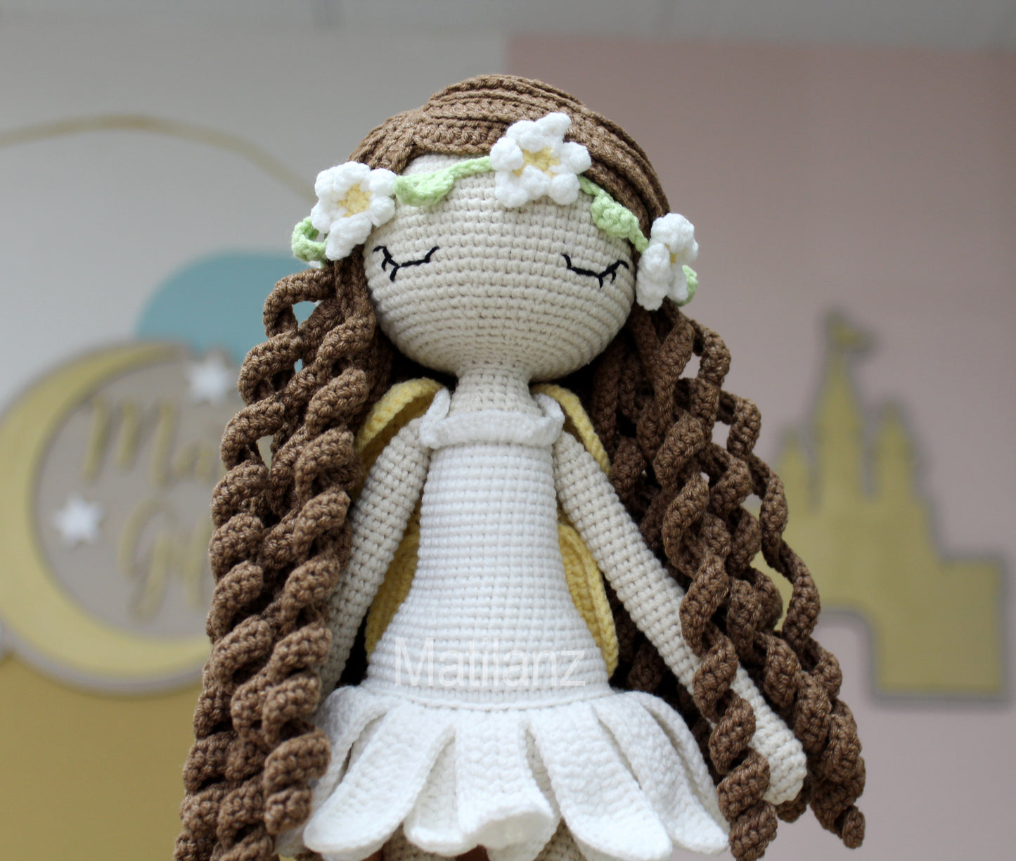 Handmade crochet fairy doll with long brown hair, white dress, and floral crown.