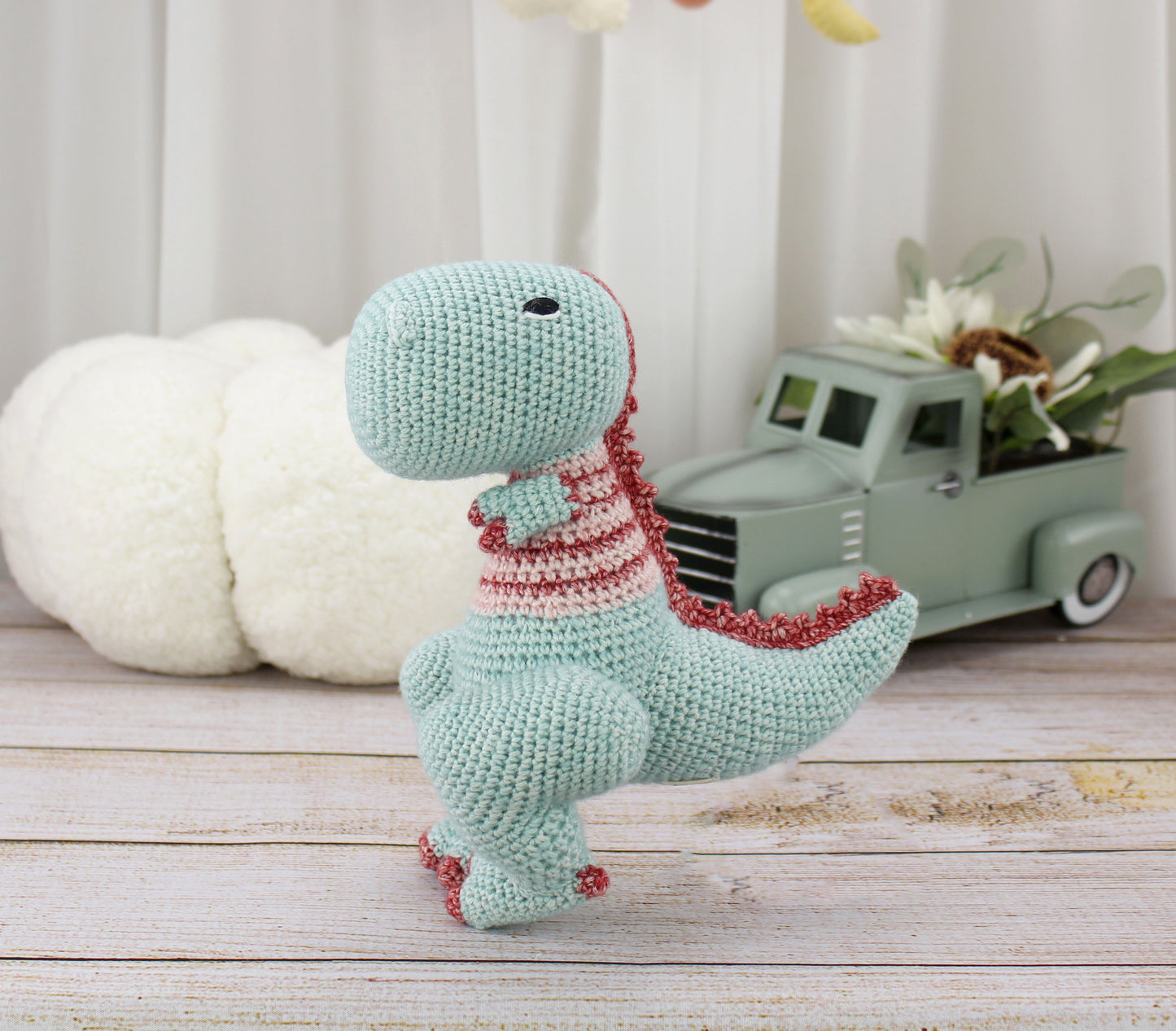 Handmade teal and red crochet T-Rex plushie, 8 inches tall with a playful design.