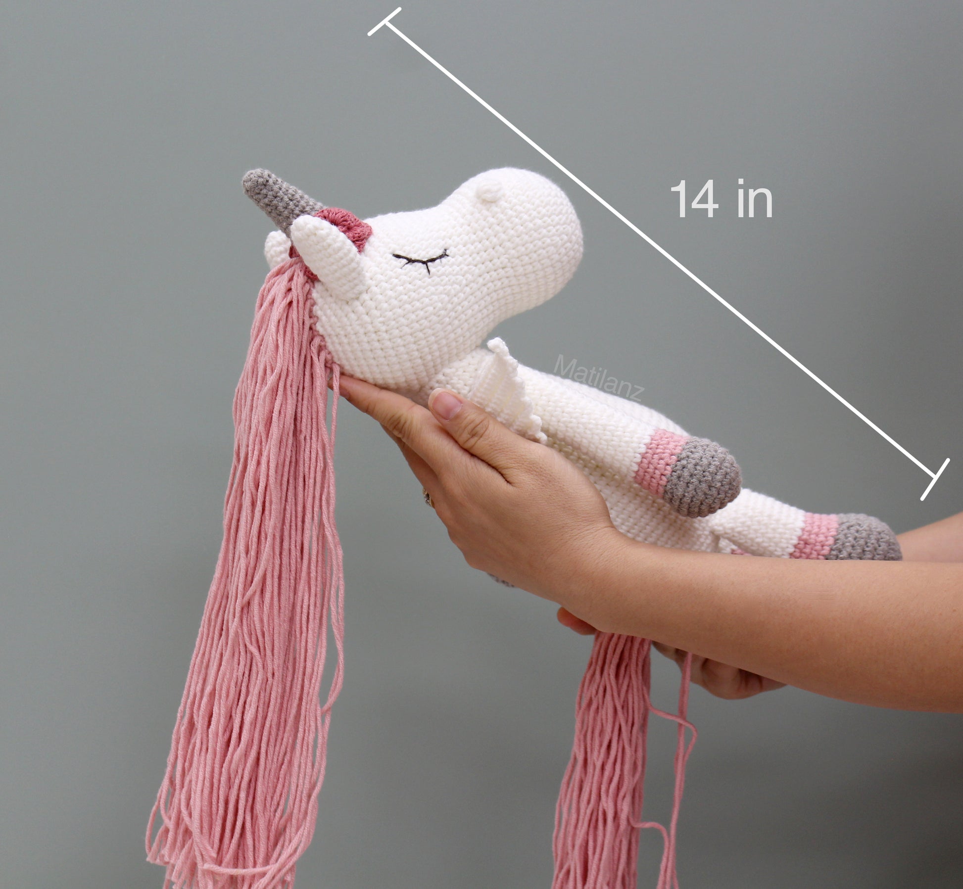 Handmade crochet winged unicorn horse with white body, pink mane, and gray hooves, measuring 14 inches.