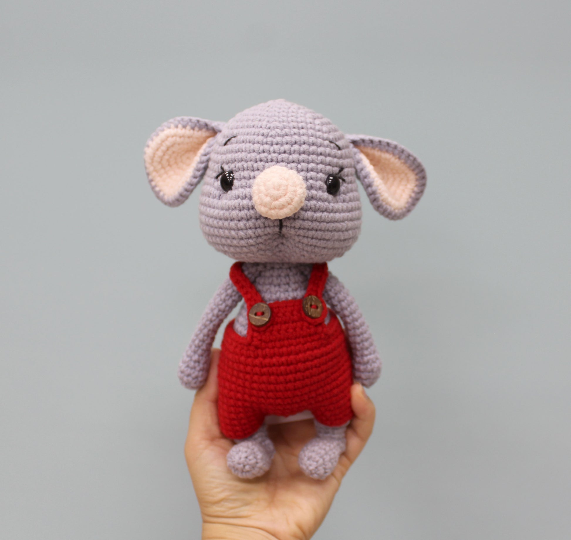 Handmade gray mouse stuffed animal in red overalls, perfect for Christmas.