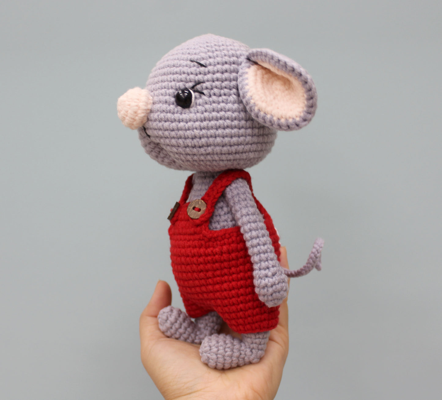 Handmade gray mouse stuffed animal wearing red overalls, perfect for Christmas.