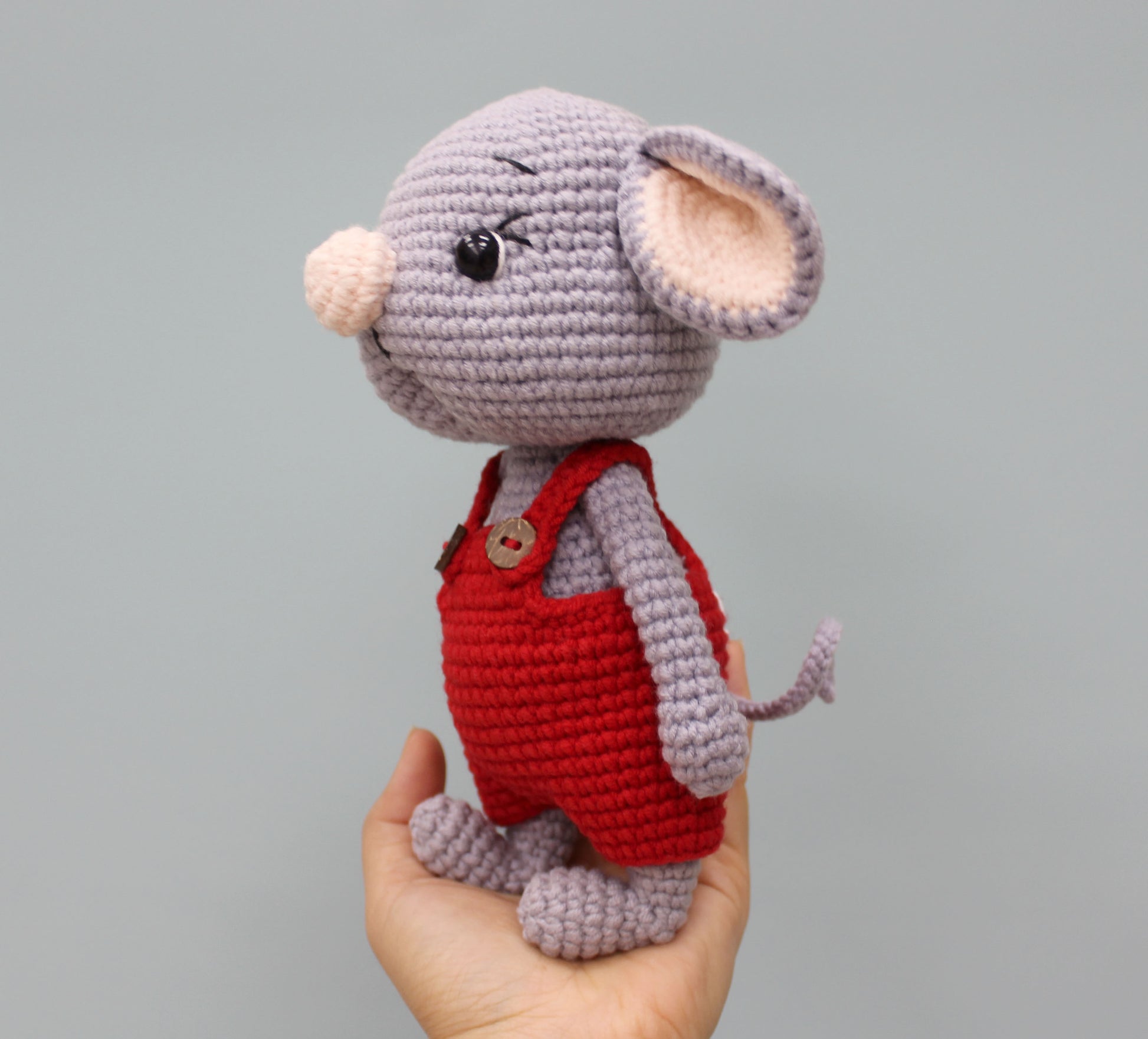 Handmade gray mouse stuffed animal wearing red overalls, perfect for Christmas.