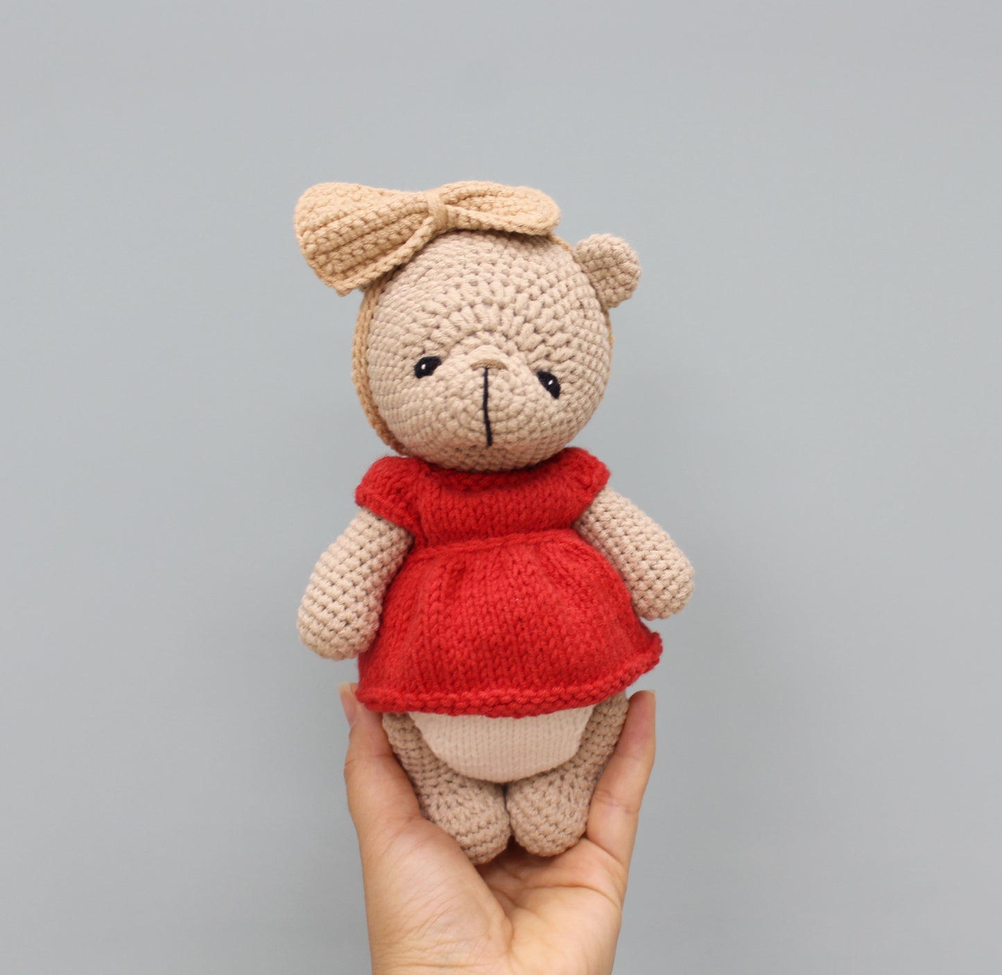Handmade 8-inch teddy bear in beige with a red dress and bow, perfect for Christmas.
