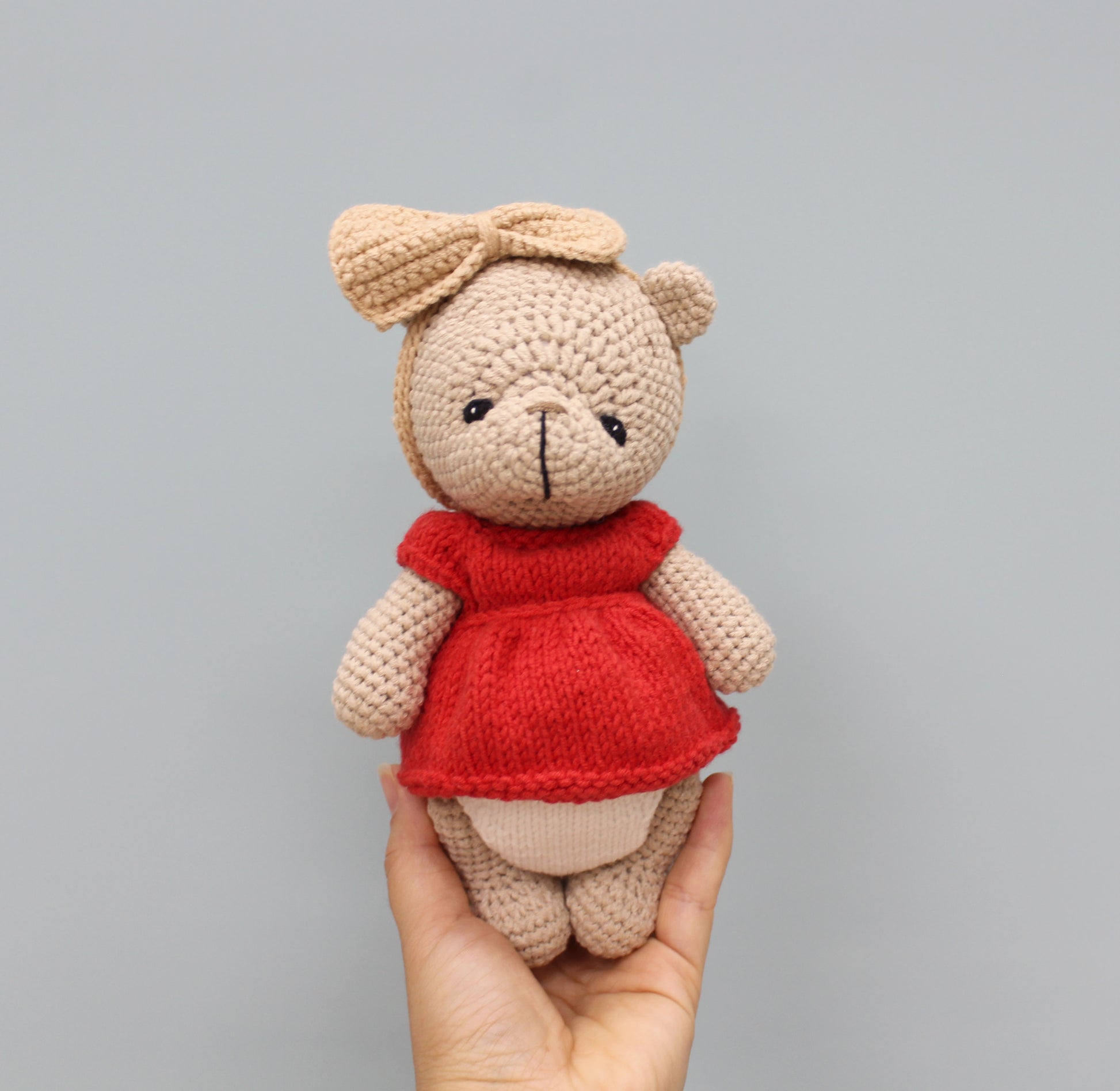 Handmade 8-inch teddy bear in beige with a red dress and bow, perfect for Christmas.