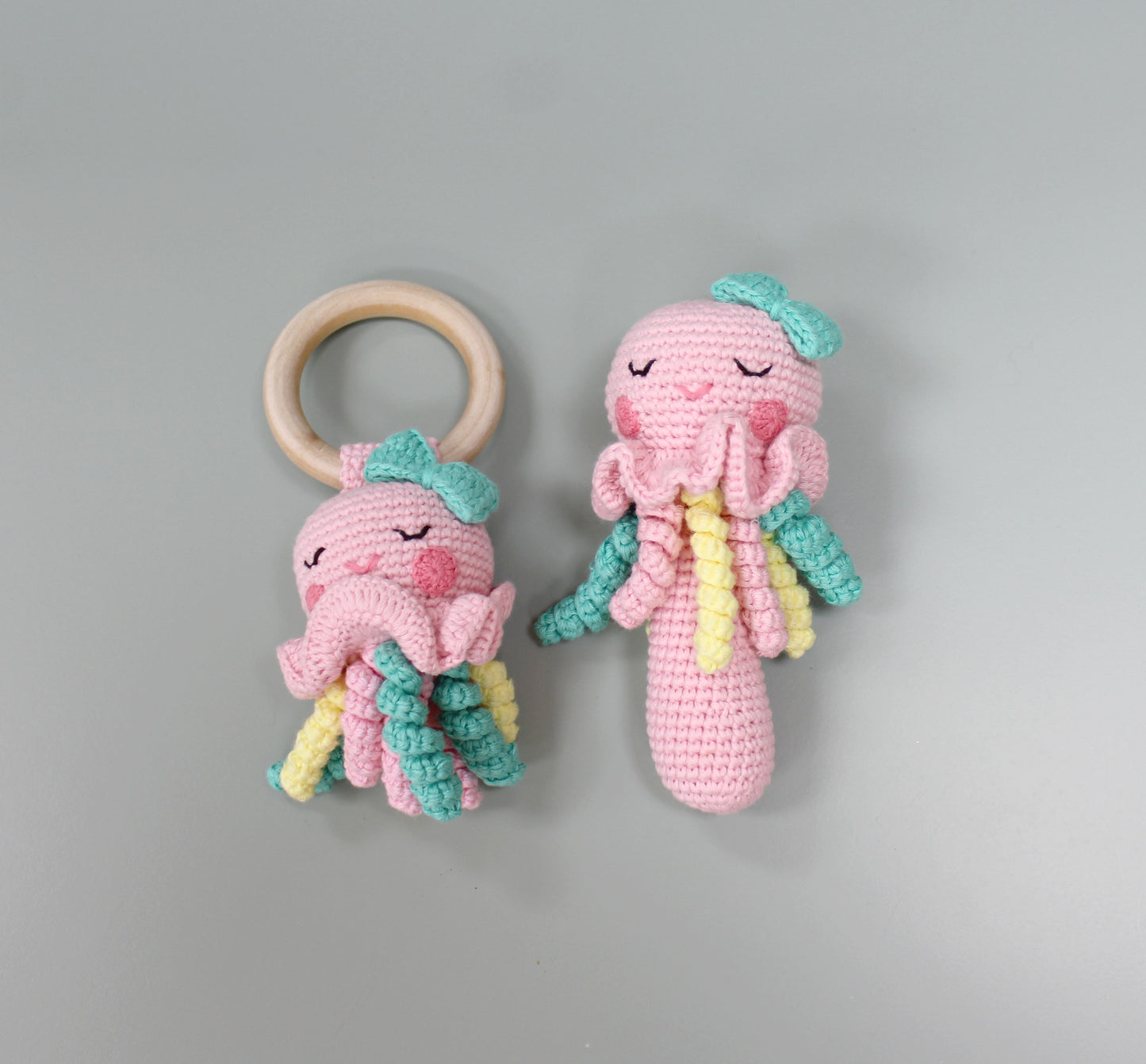 "Two-piece crocheted jellyfish rattle toy, handmade from soft cotton with pastel colors."