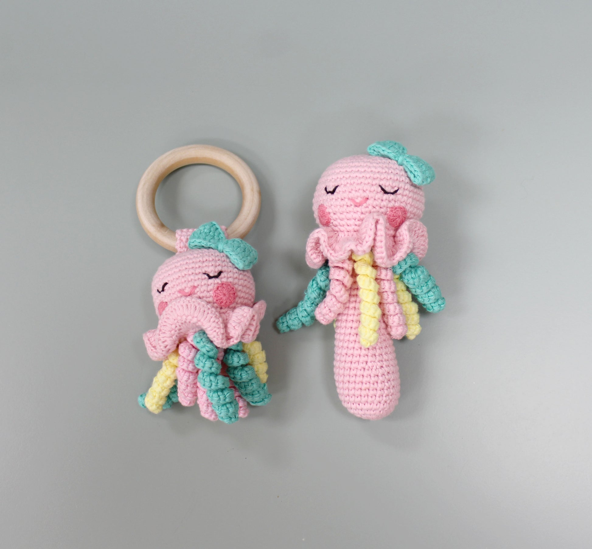 "Two-piece crocheted jellyfish rattle toy, handmade from soft cotton with pastel colors."