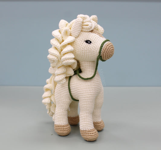 White handmade crochet horse with brown accents and flowing hair, 10 inches tall.