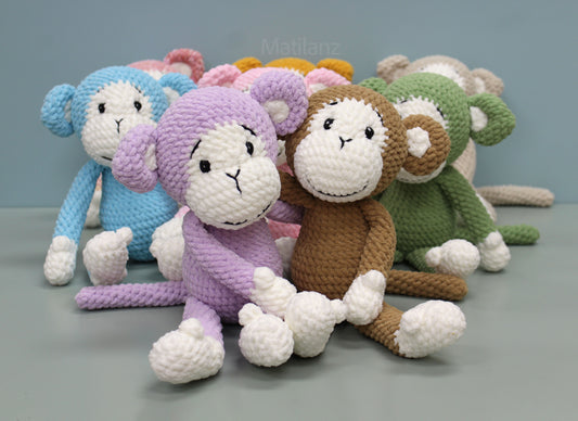 Handmade crochet monkey plush in purple, brown, and other colors, sized 11 inches.