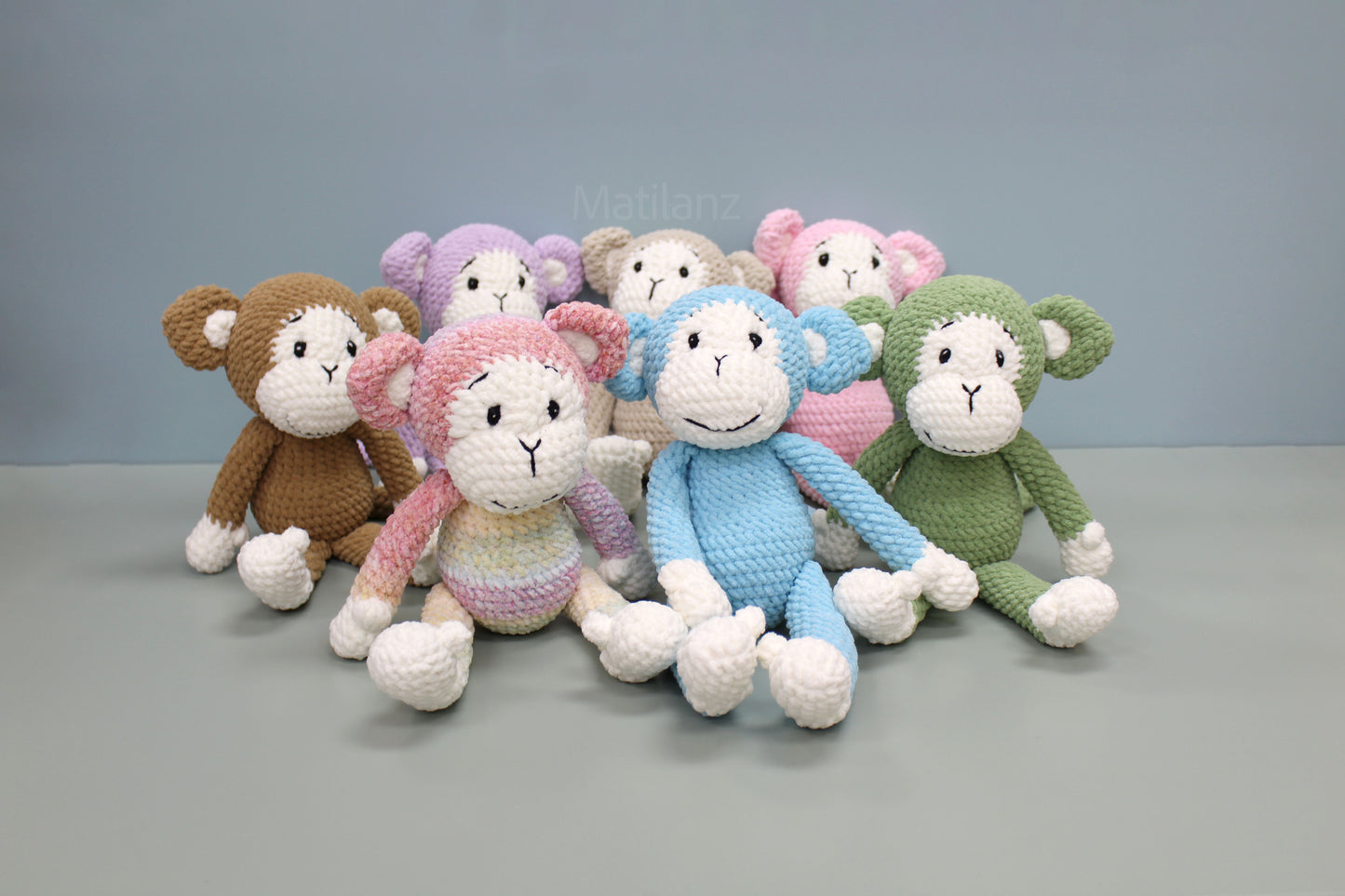 Handmade crochet monkey plush in colorful pastel tones, 11 inches tall.