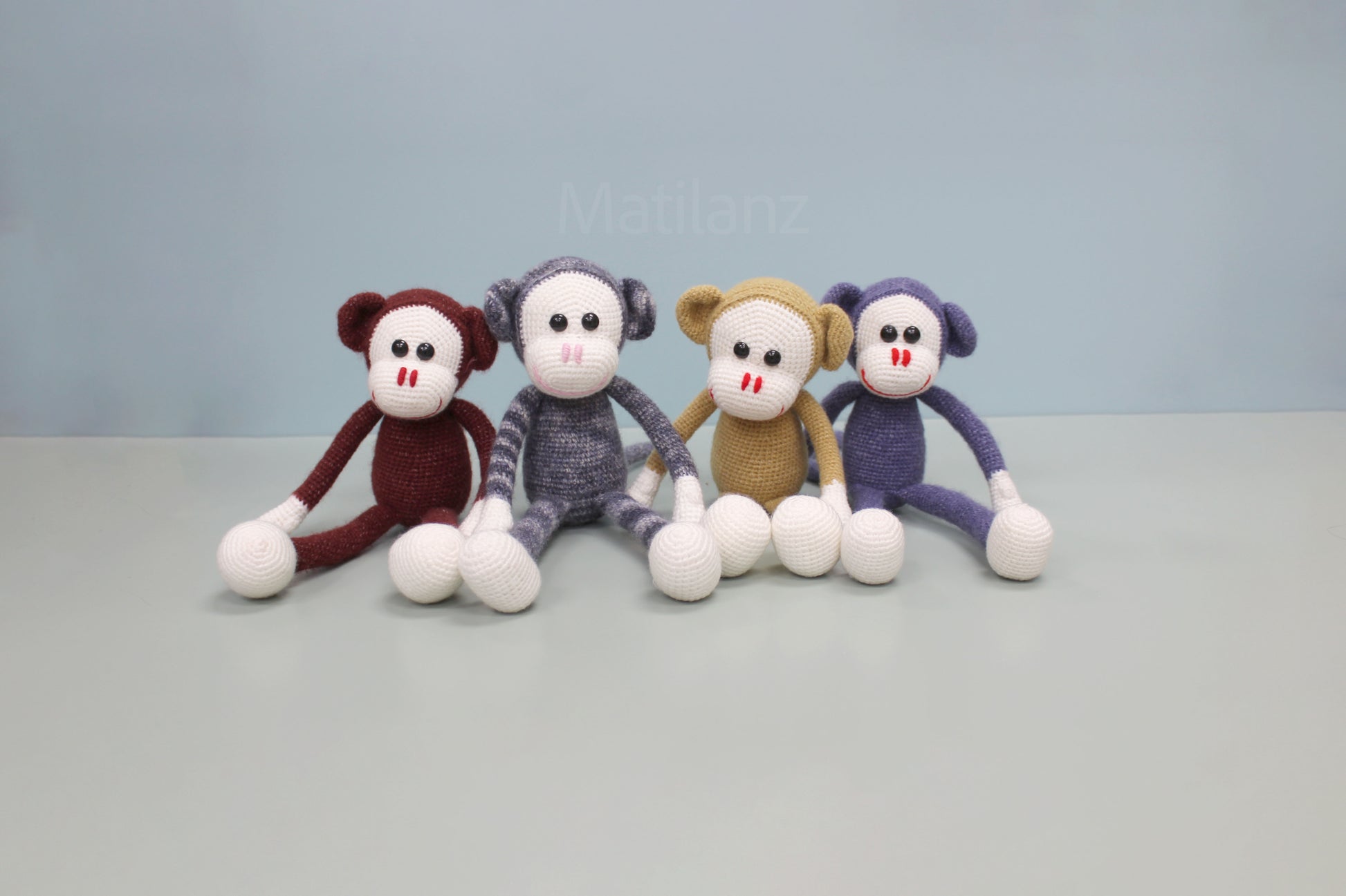 Handmade crochet monkey stuffed toy, 13 inches, in assorted colors with white hands and feet.