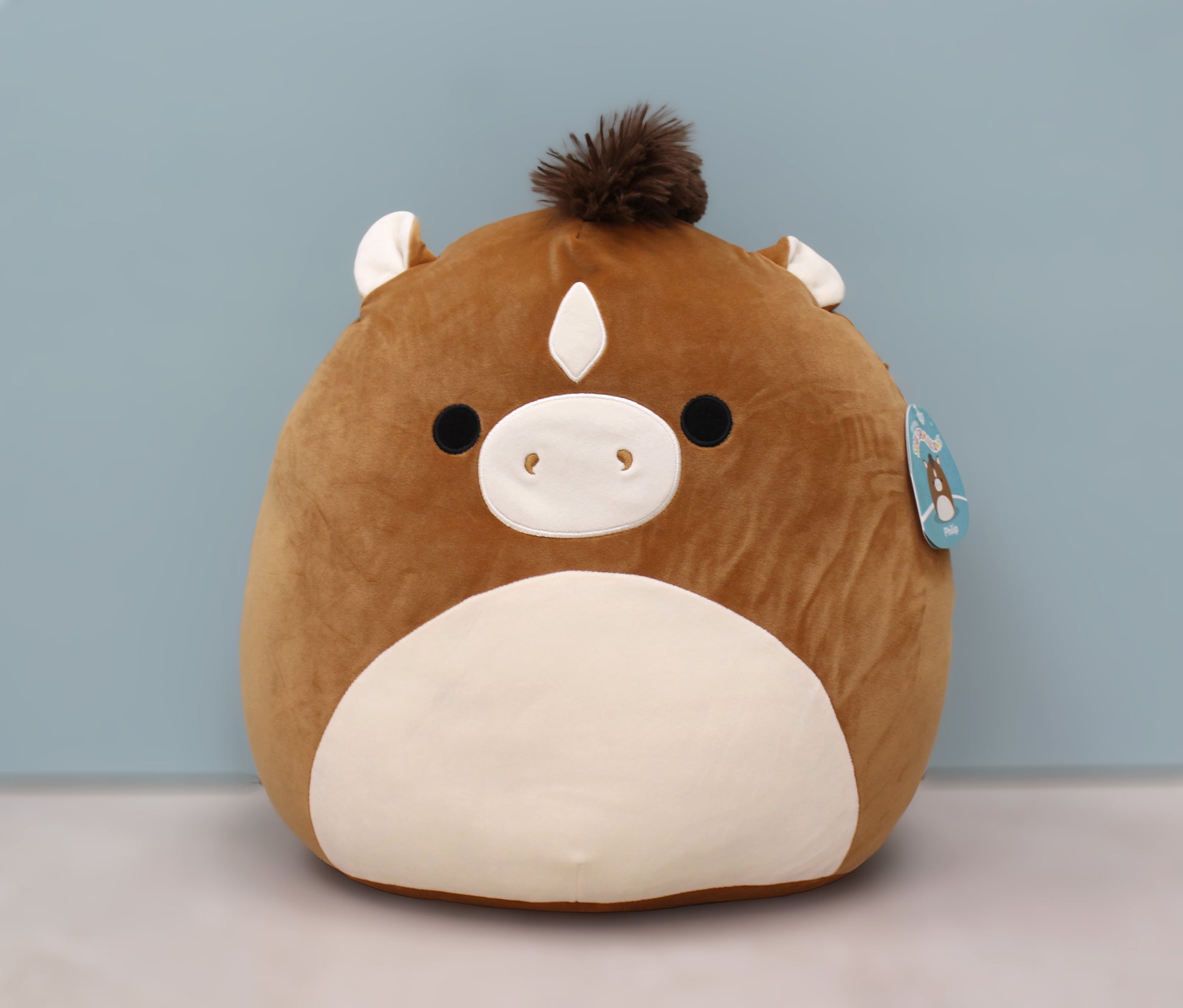 Cute brown and white plush horse with a fluffy mane, soft texture, and a cheerful expression.