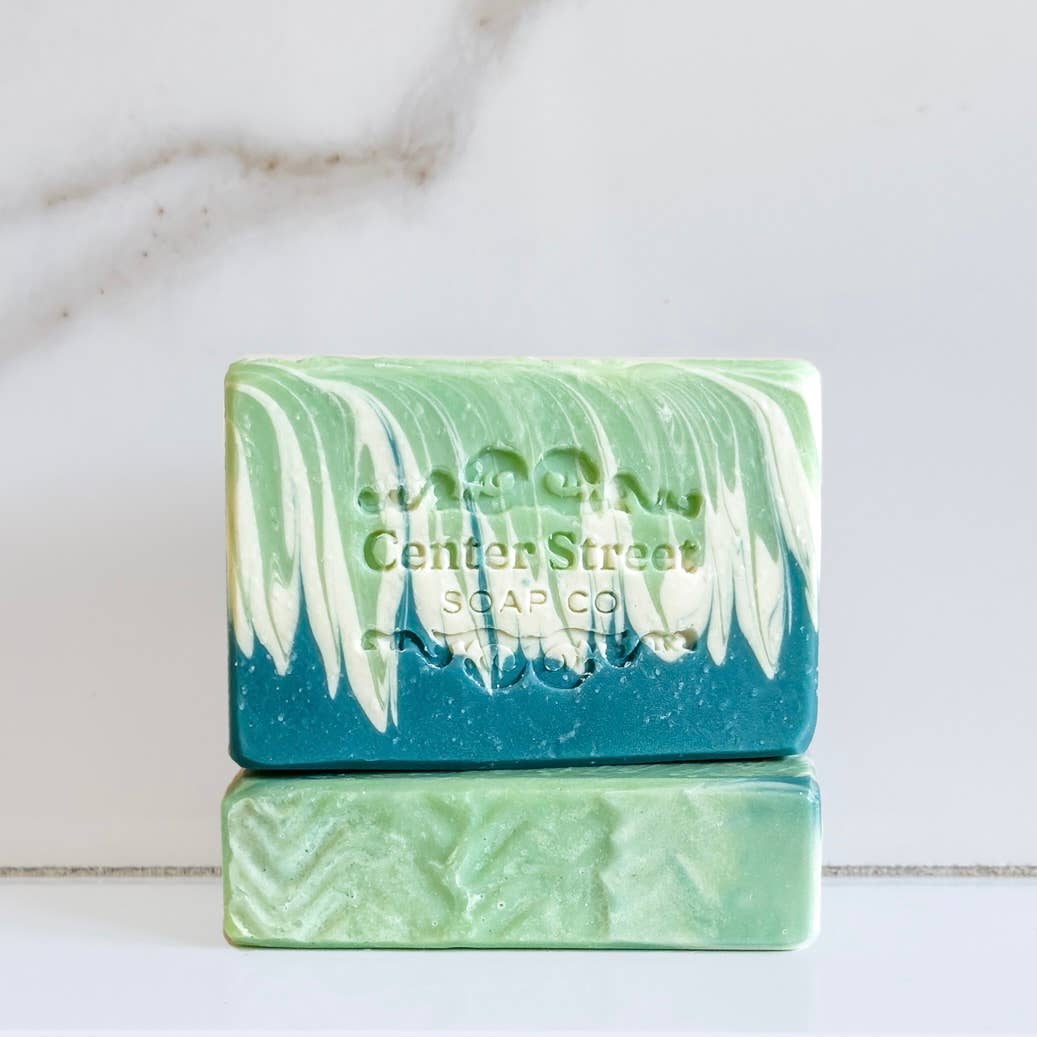 Green and teal handmade soap bar with marbled swirls