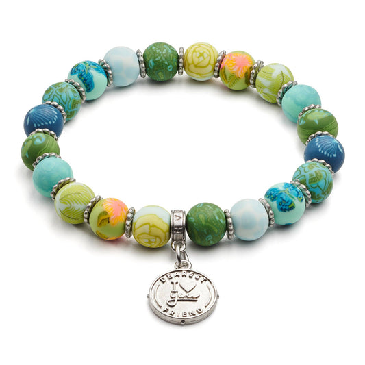 Earth-toned friendship bracelet with green and blue beads, displayed on a floral card reading “A Note to My Friend.”
