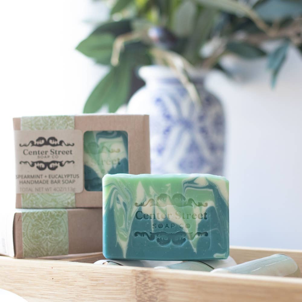 Handmade vegan soap bar with spearmint and eucalyptus, featuring a refreshing green and white swirl design.