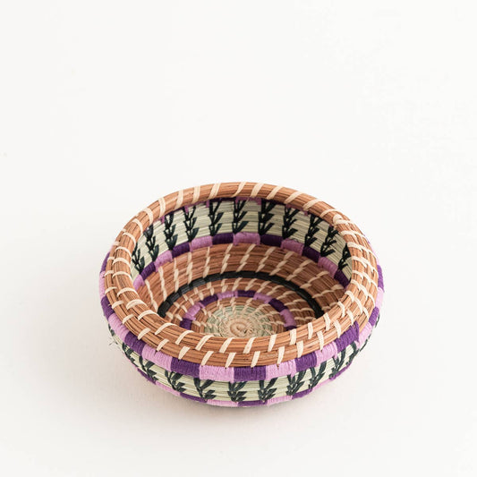 Small round basket with purple, black, and natural woven patterns