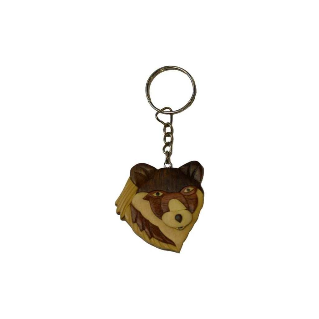 Wooden keychain featuring a carved wolf head with piercing eyes and layered wood tones, attached to a metal key ring.
