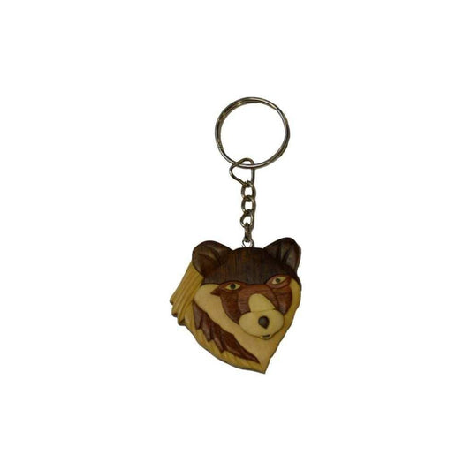 Wooden keychain featuring a carved wolf head with piercing eyes and layered wood tones, attached to a metal key ring.