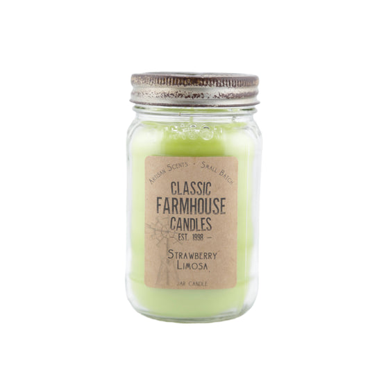 Pale green candle in a clear glass jar with "Strawberry Limosa" label and rustic metal star lid.