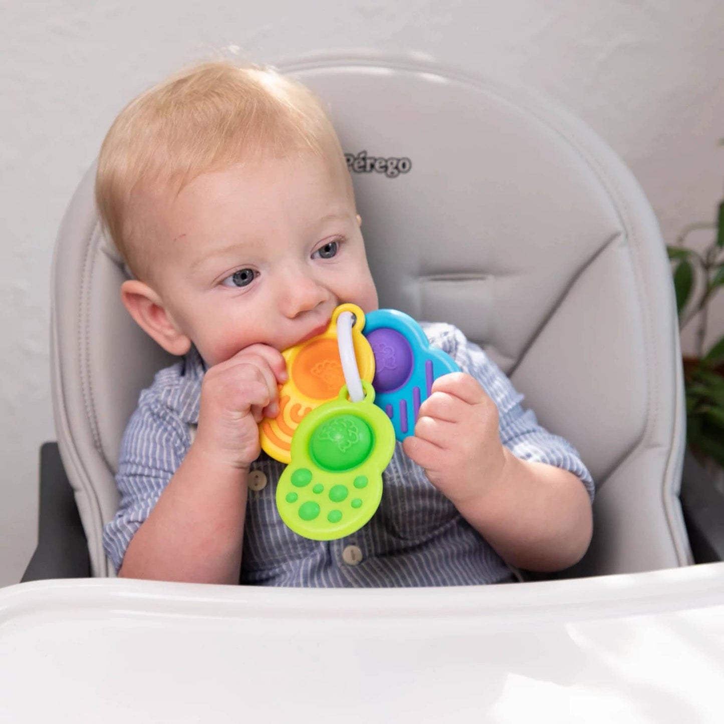Bright, colorful sensory ring toy set with textured shapes for baby's tactile play.