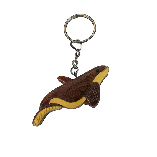 Wooden whale keychain with a rounded body, fin detail, and a smooth two-tone wood finish.