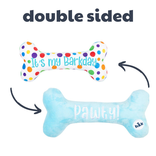 Double-sided plush bone dog toy with colorful polka dots and text