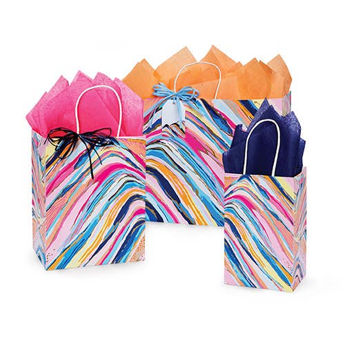 Colorful abstract gift bags in small, medium, and large sizes, featuring swirling rainbow patterns with metallic gold accents and various colored tissue paper and bows.