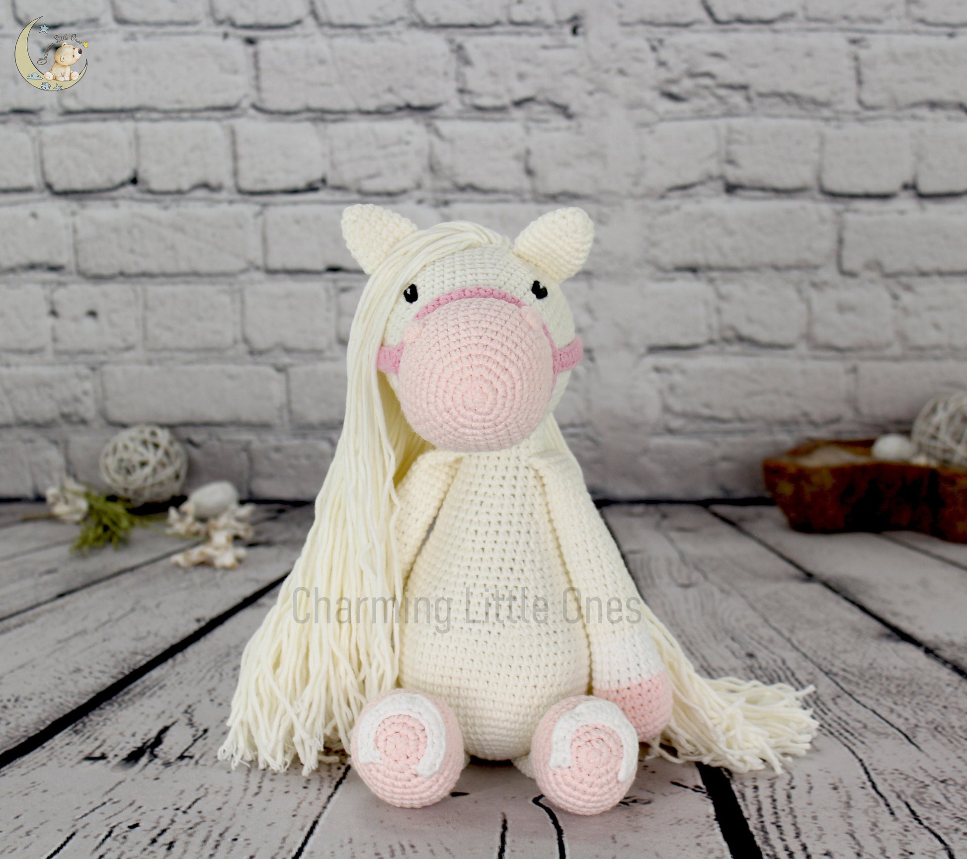 "Large handmade crochet horse with white body, pink details, and long flowing mane, perfect for decorating and cuddling."