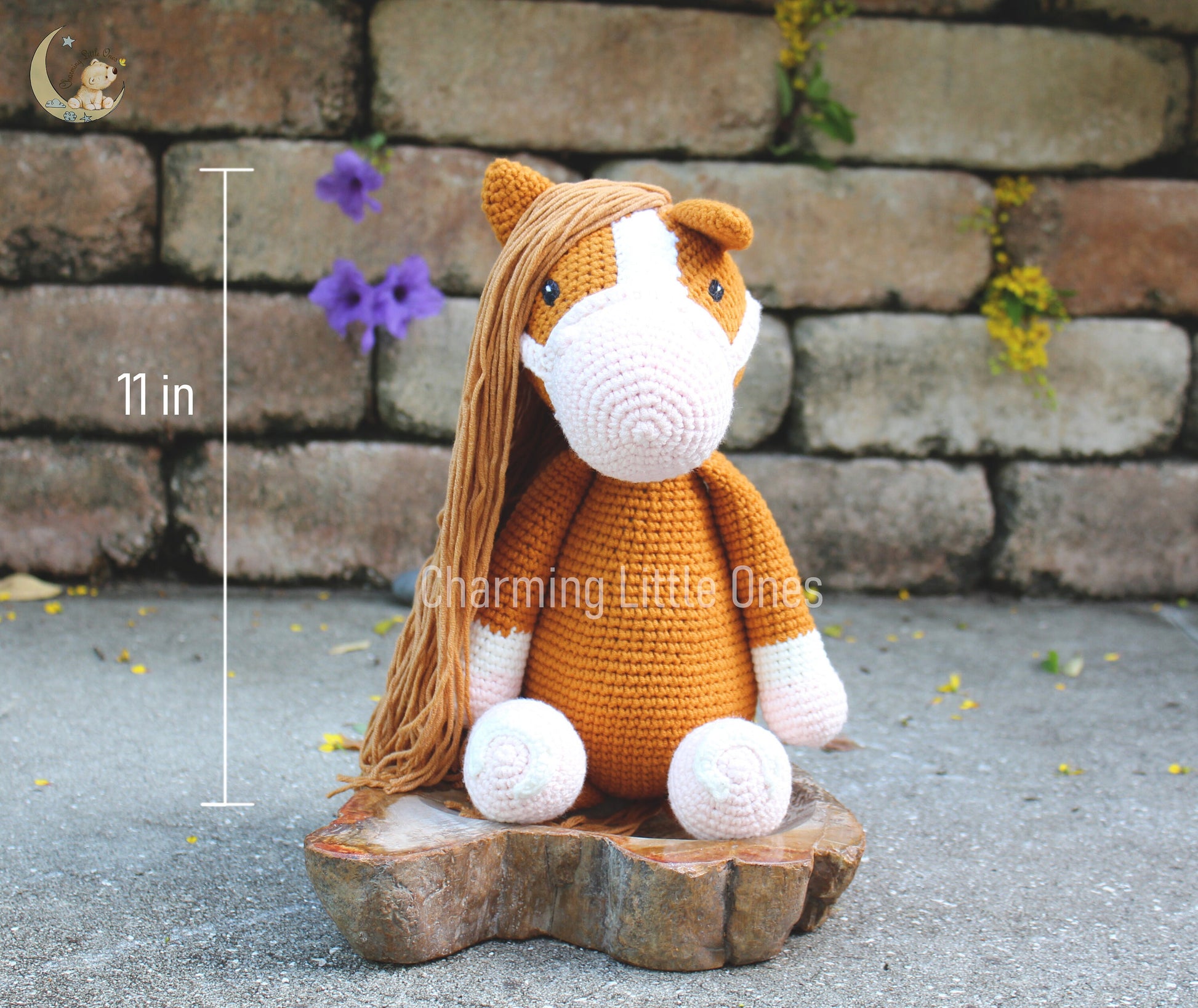 Handmade crochet horse in warm brown and white, sitting with a long mane and expressive eyes.