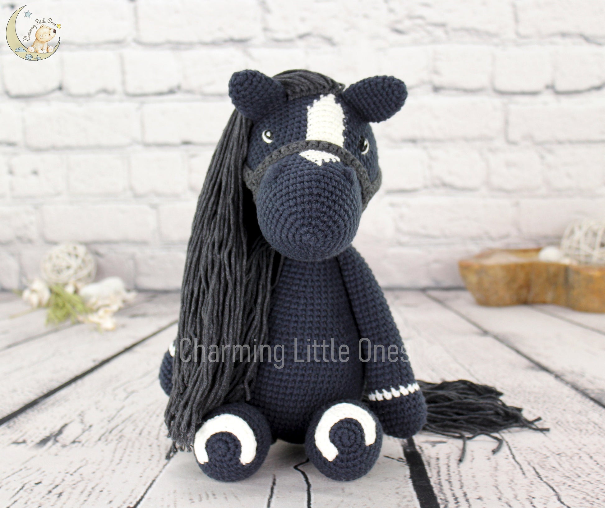 Handmade crochet horse, 13 inches tall, black with white accents, featuring a detailed mane and tail.