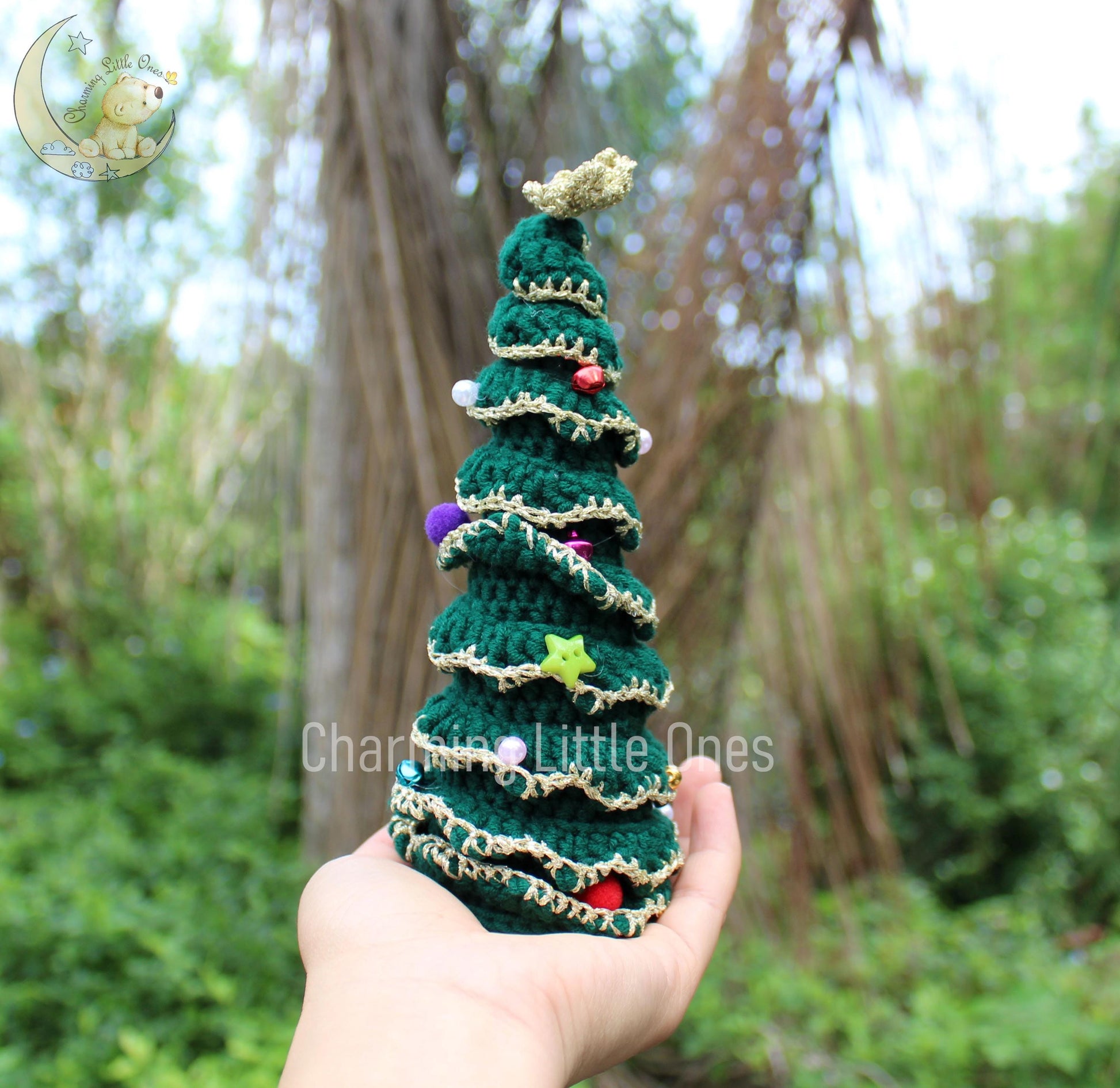 Handmade crochet Christmas tree ornament in green with colorful beads and a star topper.