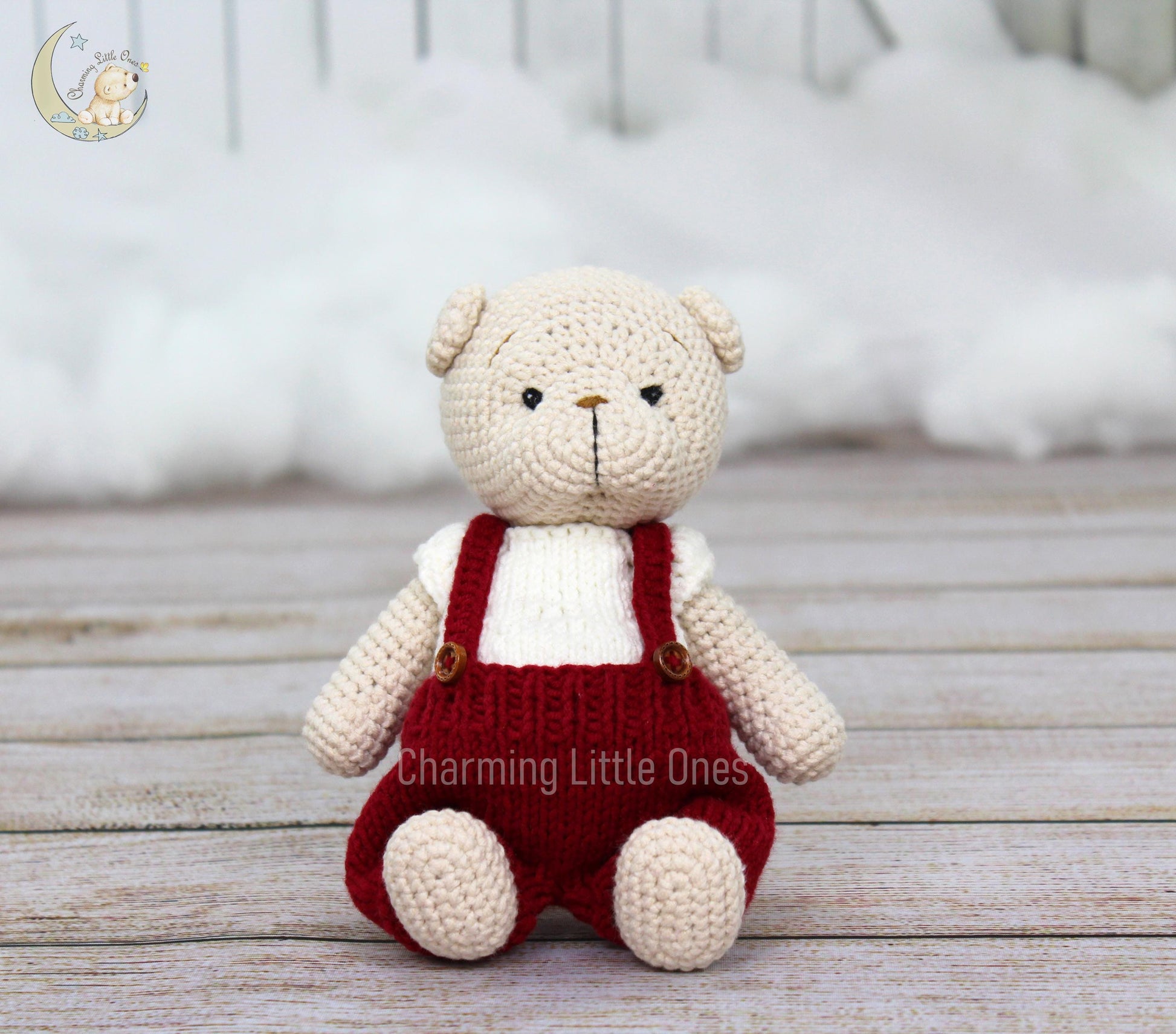 Handmade crochet bear in cream with red overalls, perfect for Christmas.