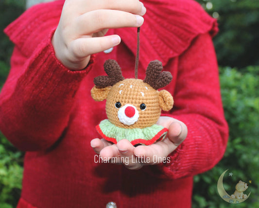 Cute crochet reindeer ornament with brown body, red nose, and green collar.