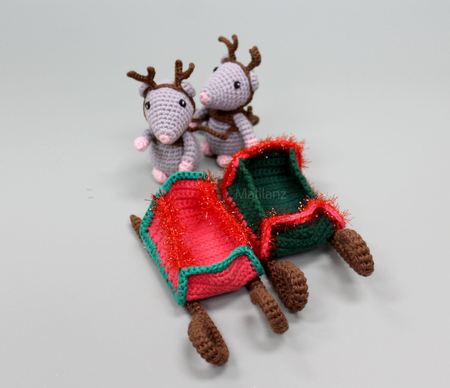 Hand-crocheted set featuring two mice with antlers, two sleighs in red and green with brown accents.